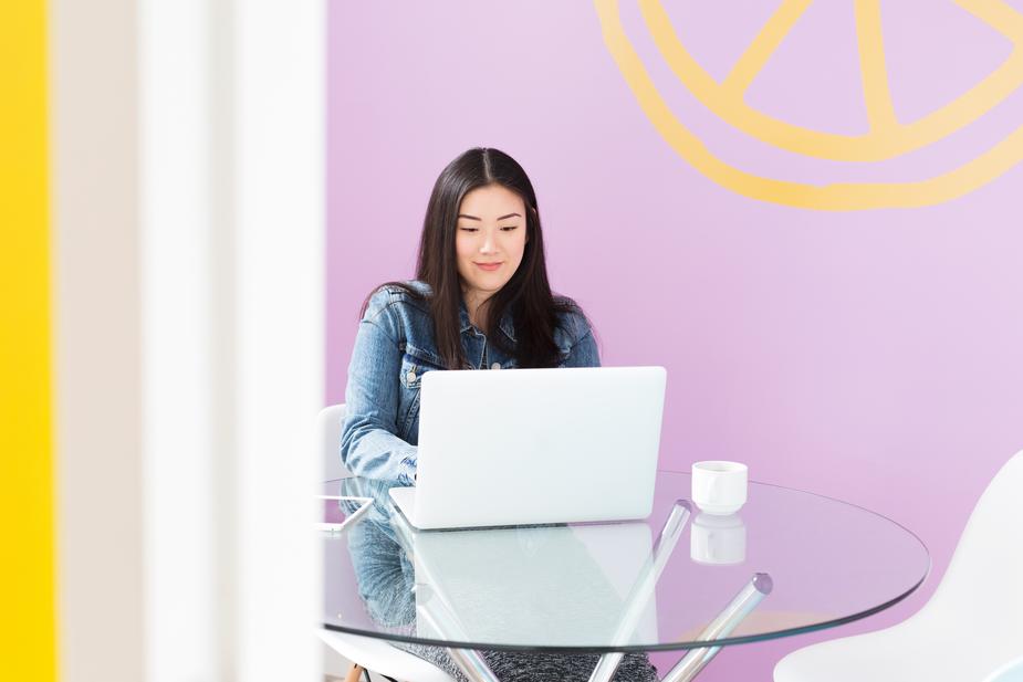 pink office space, woman on laptop -- -- coworking leaders